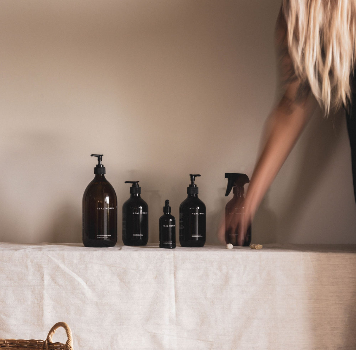 The Reset. Real World products lined up on a linen bench.